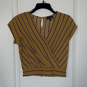 This is a yellow business casual top with black & white stripes, size small.